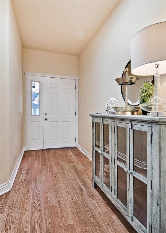 entryway featuring wood finished floors and baseboards