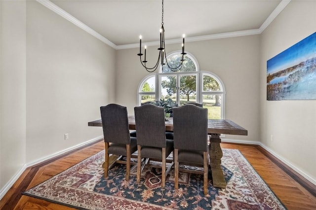 dining space featuring crown molding, hardwood / wood-style floors, and a chandelier