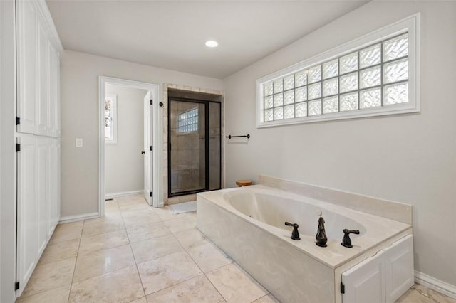 bathroom with tile patterned flooring and independent shower and bath