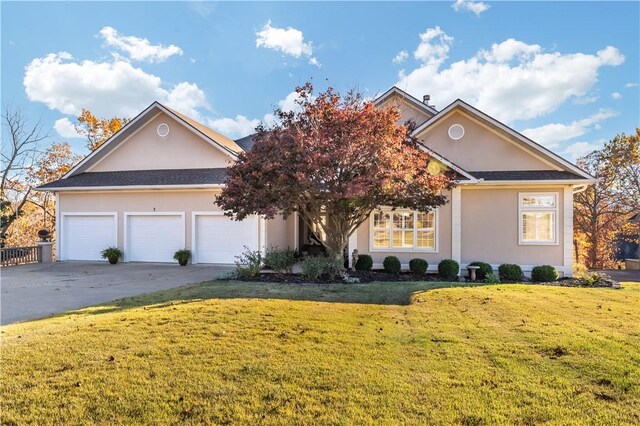 view of front of house with a garage and a front yard