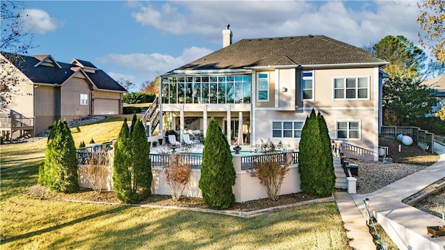 rear view of property featuring a lawn