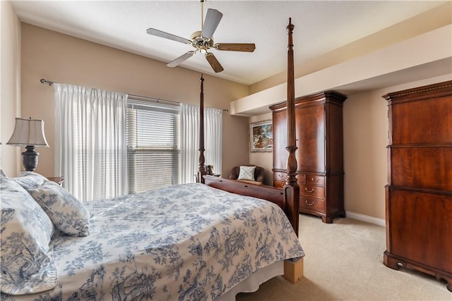 bedroom with ceiling fan and light colored carpet