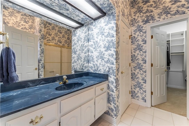 bathroom featuring tile patterned flooring and vanity