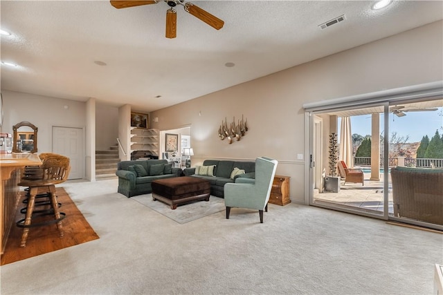 living room with a textured ceiling and light colored carpet