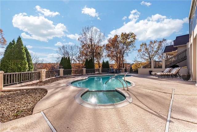 view of swimming pool with an in ground hot tub and a patio area