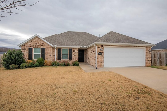 single story home featuring a garage and a front yard