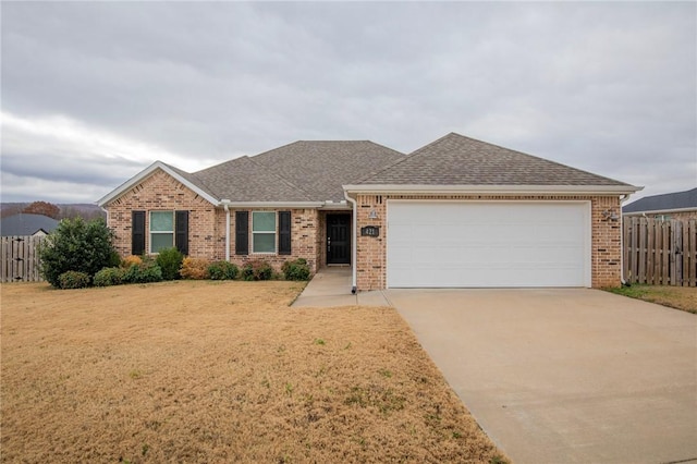 ranch-style house featuring a front yard and a garage