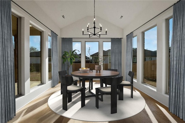 4201 88th St, Bentonville, AR 72718 - sunroom featuring a chandelier, wood finished floors, visible vents, and high vaulted ceiling