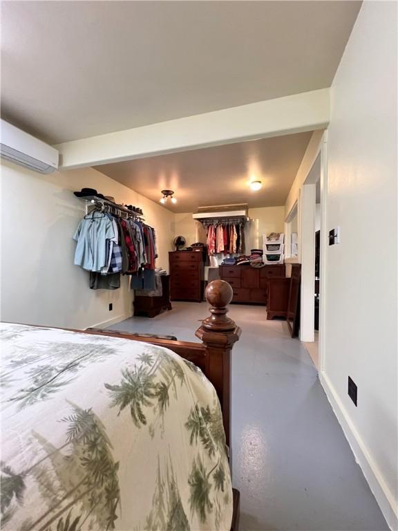 bedroom featuring a wall unit AC