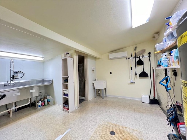 basement featuring an AC wall unit and sink