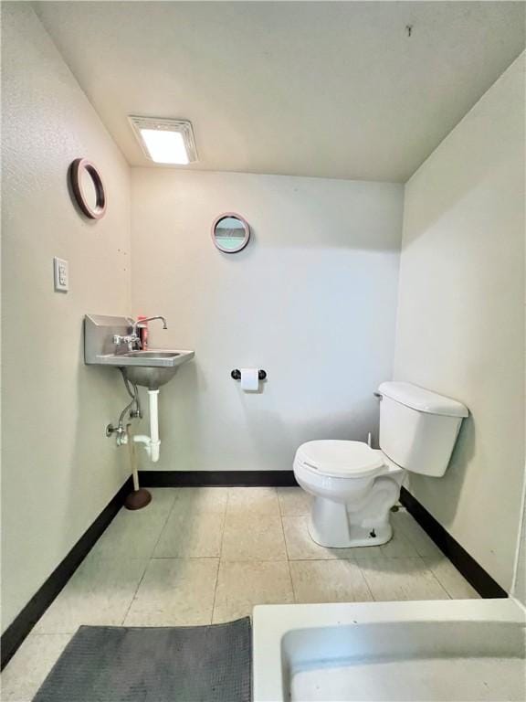 bathroom featuring tile patterned floors and toilet