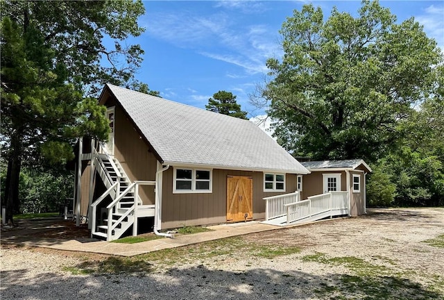 426 Van Buren, Eureka Springs, AR 72632 - view of front of home featuring stairway, a wooden deck, and roof with shingles