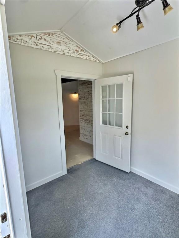 426 Van Buren, Eureka Springs, AR 72632 - spare room with vaulted ceiling and carpet flooring