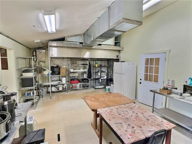 426 Van Buren, Eureka Springs, AR 72632 - kitchen with freestanding refrigerator and vaulted ceiling
