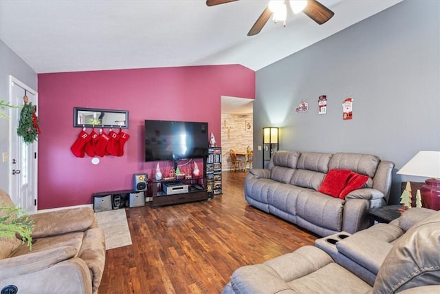 living area featuring lofted ceiling, a ceiling fan, and wood finished floors