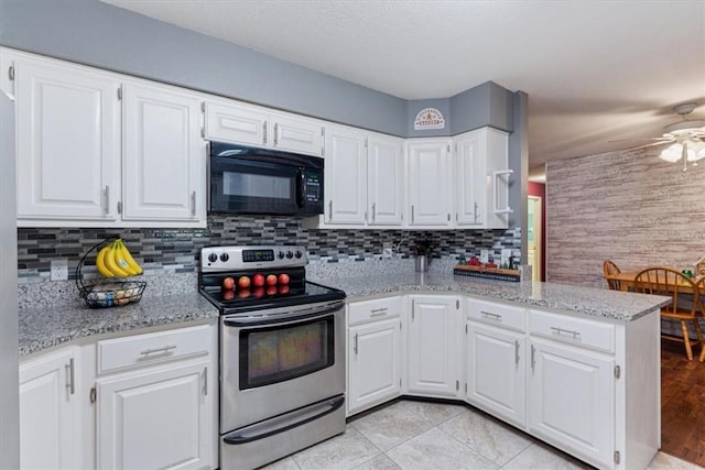 kitchen with black microwave, white cabinets, and stainless steel electric range