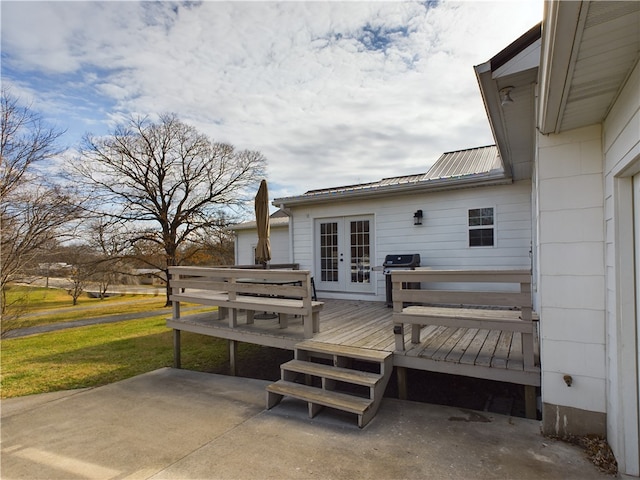 wooden terrace featuring grilling area and french doors