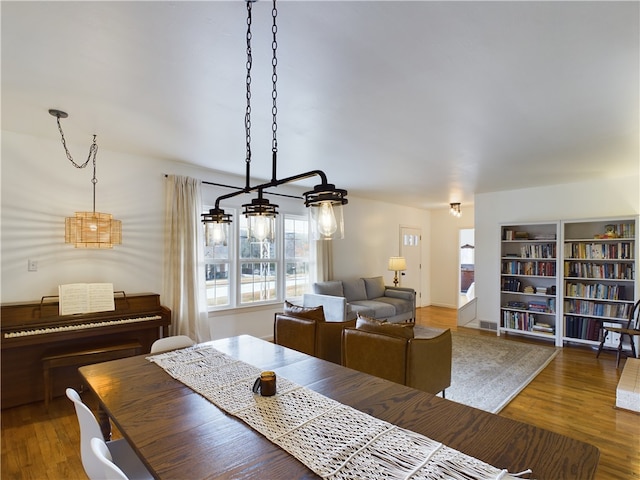 dining space with a chandelier and hardwood / wood-style flooring