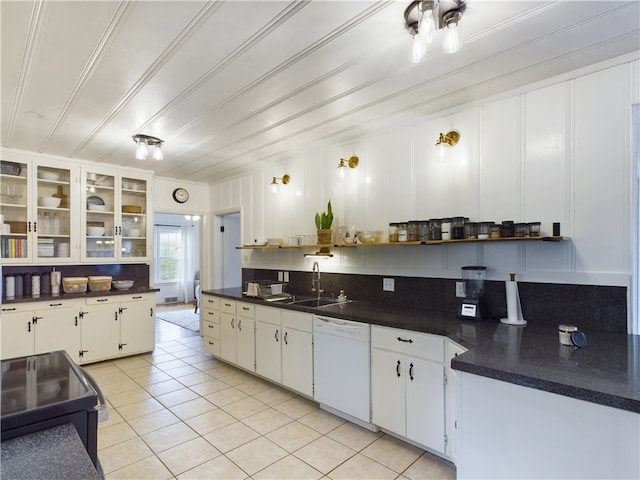 kitchen with backsplash, white dishwasher, sink, light tile patterned floors, and white cabinets