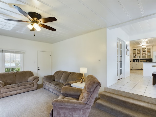 living room with light tile patterned floors and ceiling fan