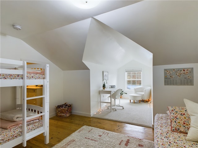 bedroom featuring hardwood / wood-style flooring and lofted ceiling