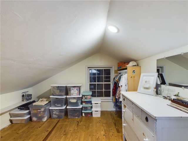 spacious closet featuring hardwood / wood-style floors and vaulted ceiling