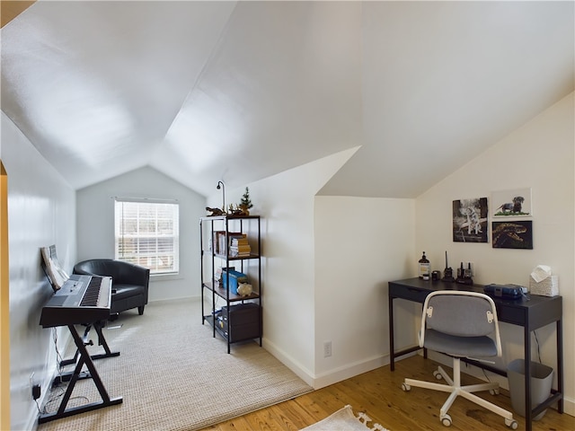 home office featuring wood-type flooring and vaulted ceiling