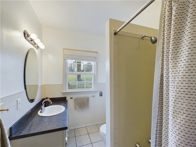 bathroom featuring walk in shower, vanity, tile walls, tile patterned flooring, and toilet