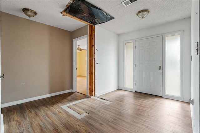 entrance foyer featuring wood-type flooring and a textured ceiling