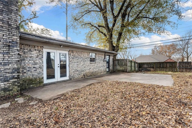 view of yard featuring a patio area and french doors