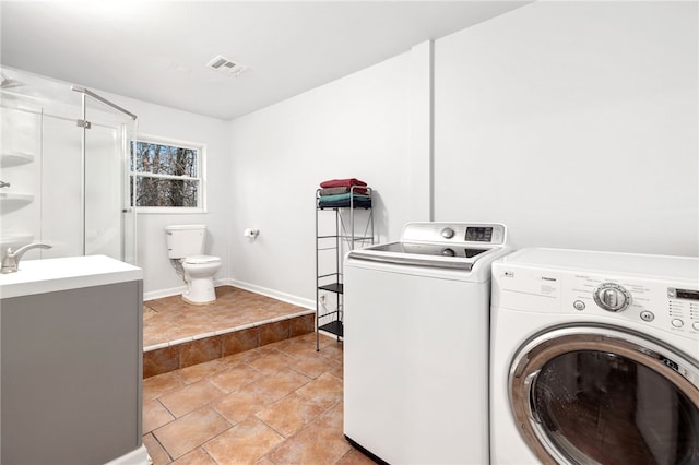 clothes washing area featuring washing machine and clothes dryer and sink