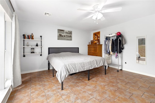 tiled bedroom with ceiling fan