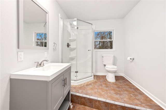 bathroom with an enclosed shower, vanity, and toilet