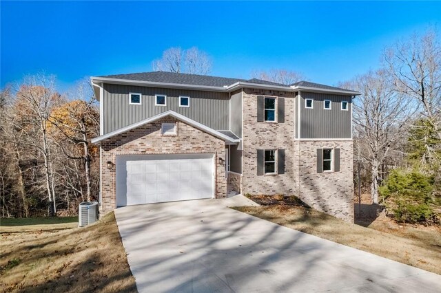8893 Williams Rd, Rogers, AR 72756 - traditional-style house featuring brick siding, a garage, and concrete driveway