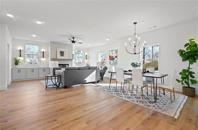 8893 Williams Rd, Rogers, AR 72756 - dining area with light wood-type flooring, a chandelier, healthy amount of natural light, ceiling fan, and recessed lighting