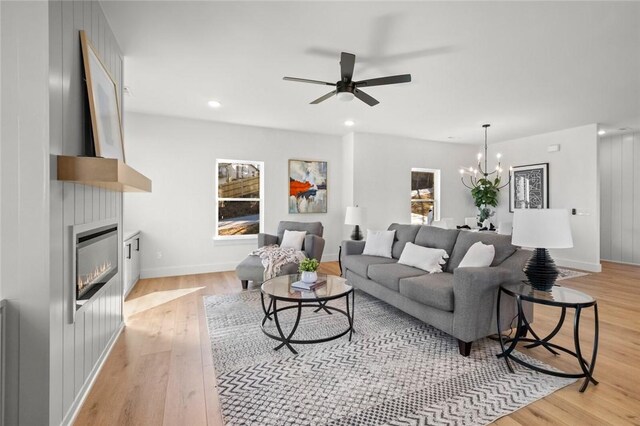 8893 Williams Rd, Rogers, AR 72756 - living area featuring light wood-style floors, ceiling fan, a chandelier, a large fireplace, and recessed lighting