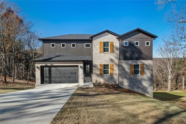 view of front of property with a garage and a front lawn