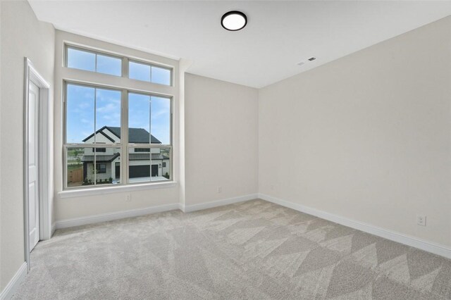 445 Fox Trl, Elm Springs, AR 72762 - spare room featuring carpet floors and baseboards