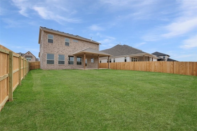 445 Fox Trl, Elm Springs, AR 72762 - rear view of house featuring brick siding, a fenced backyard, and a yard