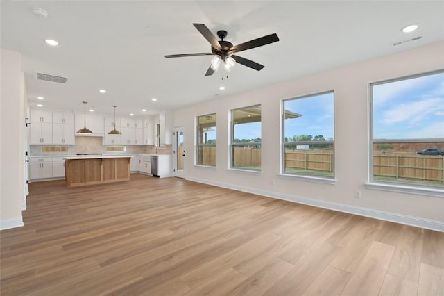 445 Fox Trl, Elm Springs, AR 72762 - unfurnished living room with recessed lighting, ceiling fan, light wood-type flooring, and visible vents