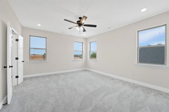 445 Fox Trl, Elm Springs, AR 72762 - unfurnished bedroom featuring baseboards, ceiling fan, light carpet, and recessed lighting