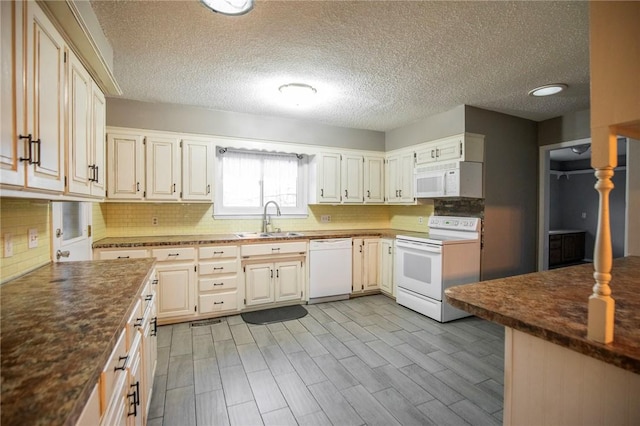 kitchen featuring tasteful backsplash, white appliances, sink, and light hardwood / wood-style flooring