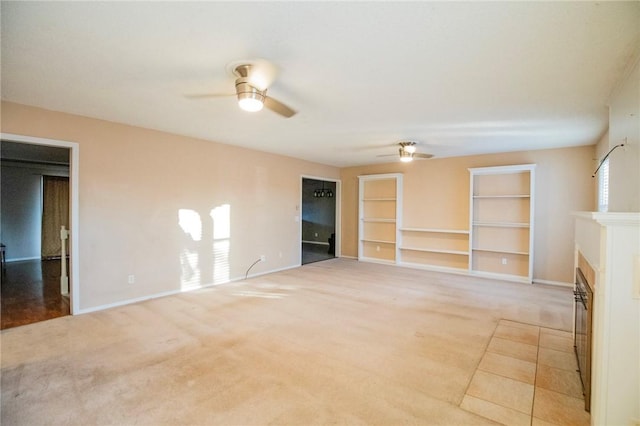 unfurnished living room featuring ceiling fan and light carpet