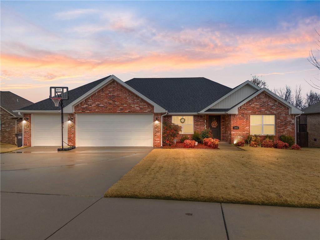 view of front of home with a yard and a garage