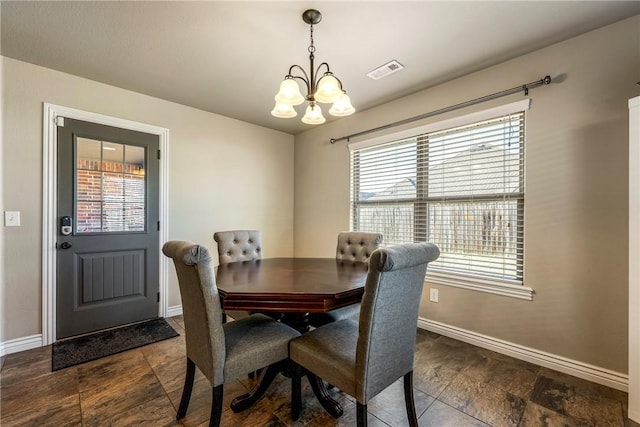 dining space with a wealth of natural light and a notable chandelier