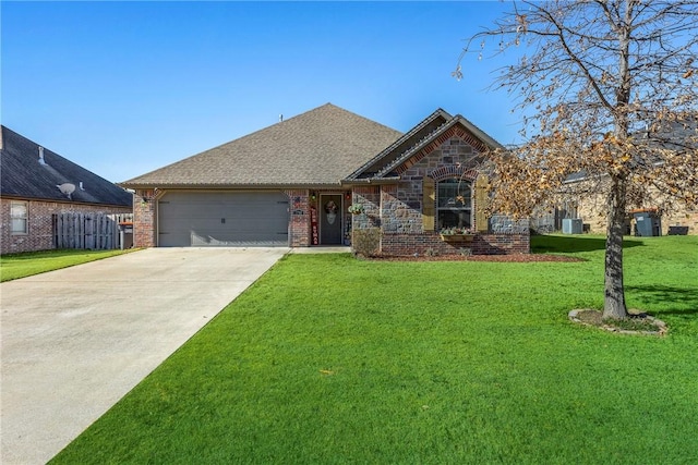 view of front facade with a garage, central air condition unit, and a front lawn