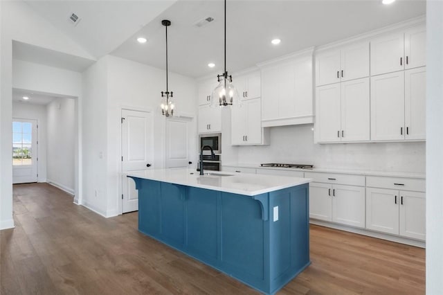 435 Fox Trl, Elm Springs, AR 72762 - kitchen with a sink, wood finished floors, light countertops, white cabinets, and recessed lighting