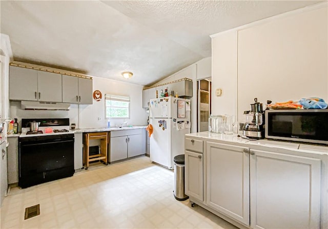 kitchen with exhaust hood, sink, vaulted ceiling, black range with electric cooktop, and white fridge