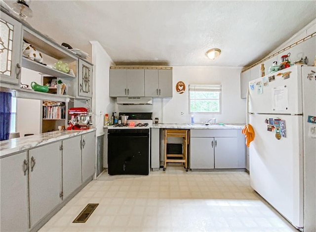 kitchen featuring gray cabinets, white appliances, and sink