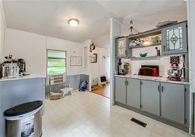 interior space featuring a textured ceiling and cooling unit